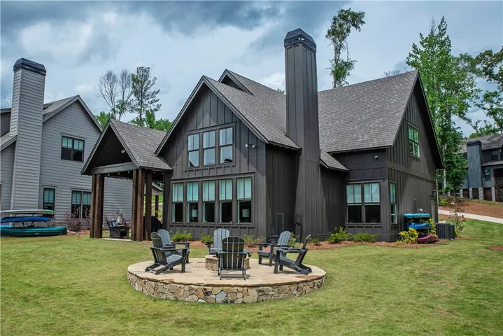 This captivating home boasts a spacious yard with a charming fire pit, perfect for gatherings.