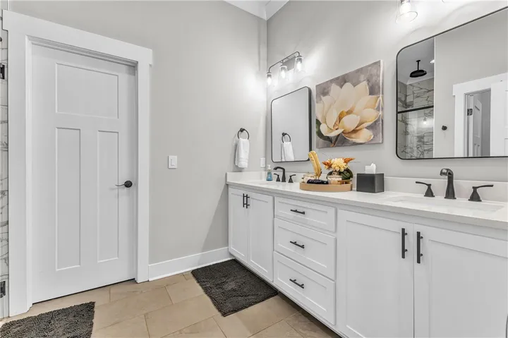 This bathroom features a double vanity and tile​​‌​​​​‌​​‌‌​‌‌​​​‌‌​‌​‌​‌​​​‌​​ flooring.