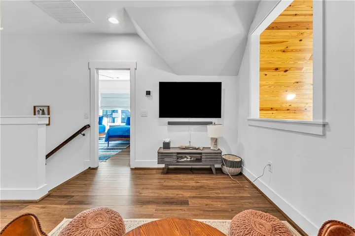 This inviting space features warm wood flooring and a modern aesthetic.
