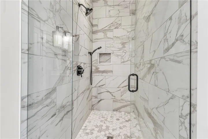 This sleek shower features modern fixtures and exquisite tiling.