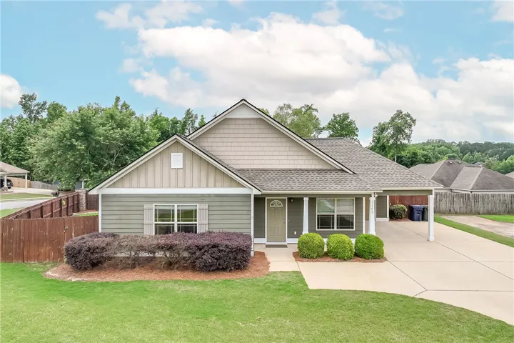 This charming residence features a well-maintained exterior and a welcoming front entrance.