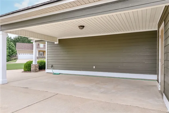 This convenient carport offers covered parking and easy access to the home's exterior entrance.