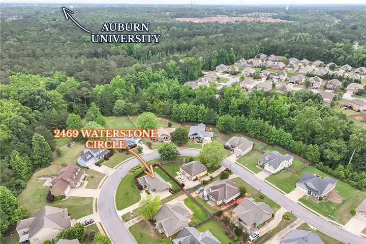 This captivating aerial view showcases a vibrant neighborhood and lush surroundings, near Auburn University.