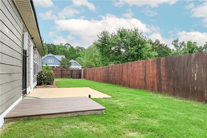 This spacious backyard offers privacy and room for outdoor enjoyment.