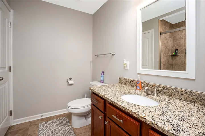 This bathroom features a sleek vanity with ample counter space and a modern shower.