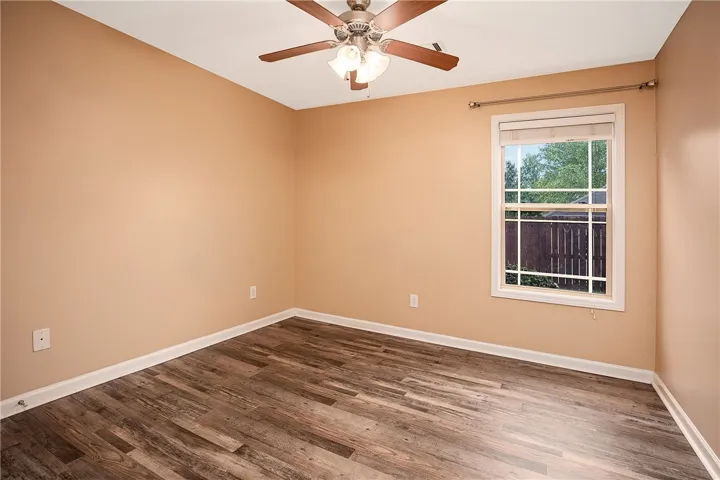 This spacious room features ample natural light and durable flooring, offering a comfortable living space.