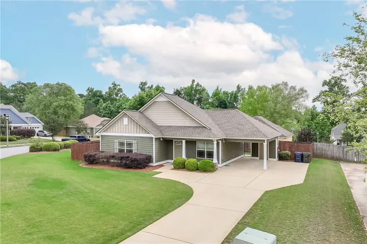 This inviting residence features a well-maintained exterior and a practical driveway, offering both charm and convenience.