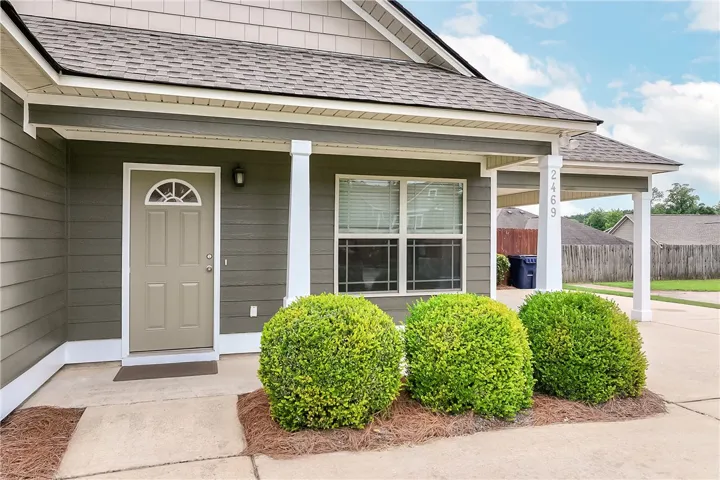 This charming residence features a welcoming front entrance with manicured landscaping.