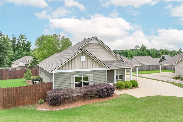This charming residence offers a spacious yard and inviting curb appeal.