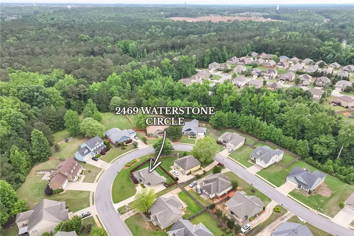 An aerial view showcases a vibrant community nestled within lush green landscapes.