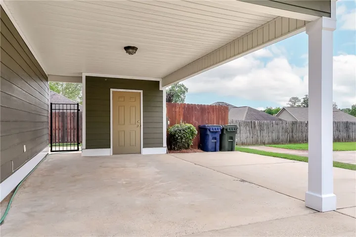 This covered carport offers protected parking and direct home access, ensuring convenience.