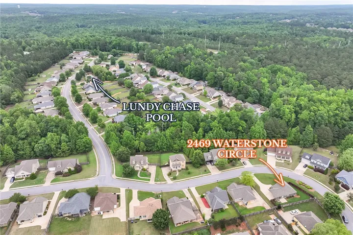 This elevated view captures a serene residential neighborhood surrounded by lush, mature trees.