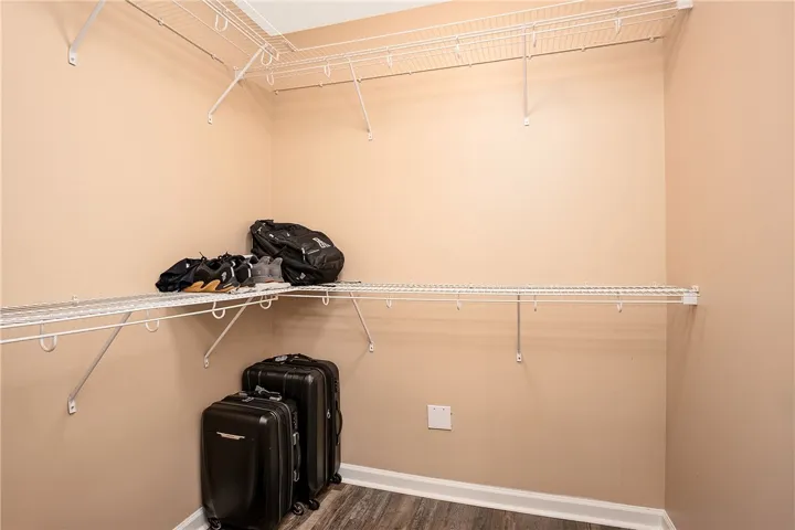 Ample closet space with wire shelving and durable flooring.