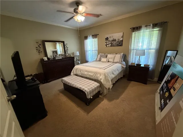 This spacious bedroom offers ample comfort and natural light.
