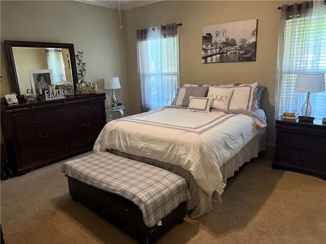 This spacious sleeping quarter offers a comfortable retreat with ample natural light.