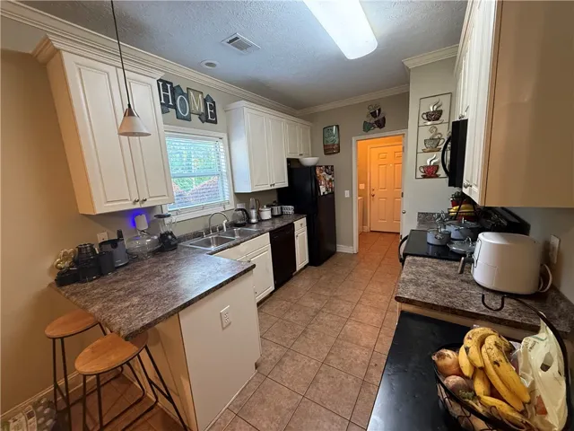 This kitchen offers functional design and ample cabinet space for effortless meal preparation.