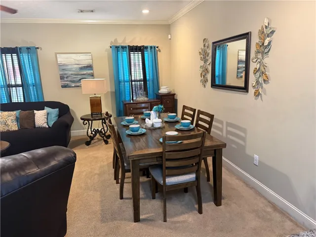 This inviting space features a dining area and a comfortable living room for everyday enjoyment.