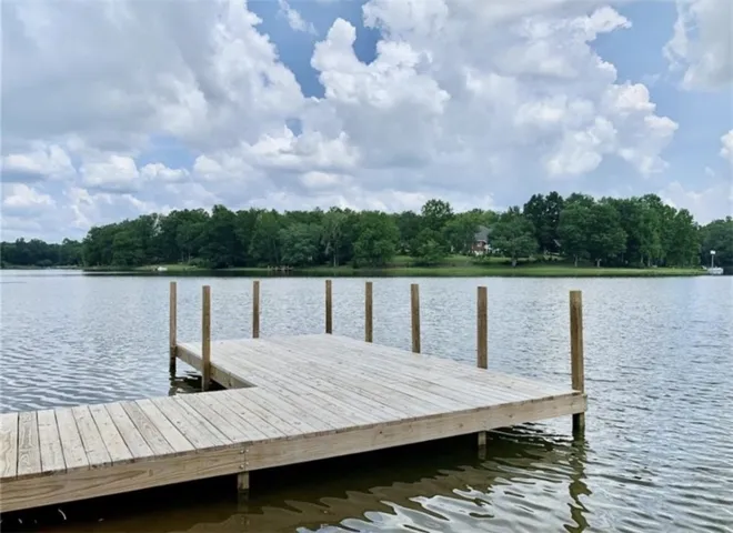 This serene waterfront property offers a private dock for direct lake access.