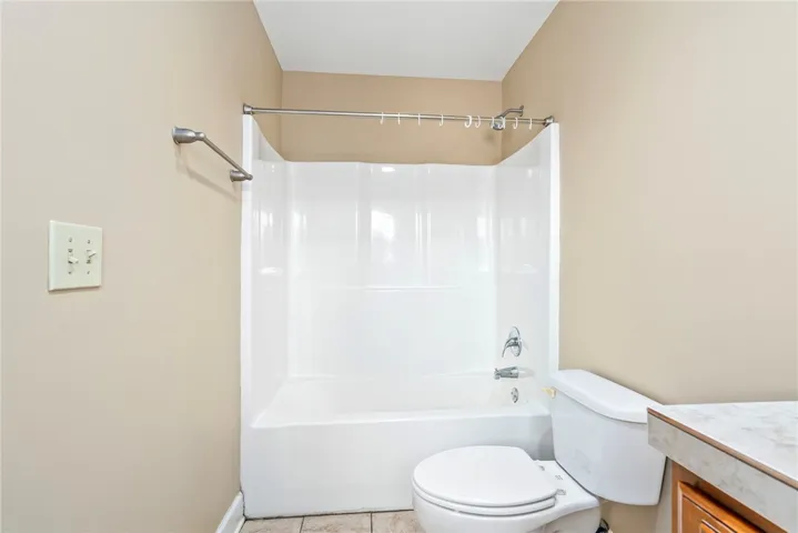 A classic bathtub and shower combination unit provides a functional and clean space.