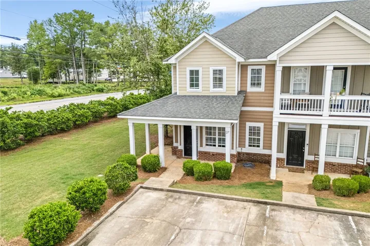 A welcoming facade offers inviting entryways, mature landscaping, and convenient parking access.