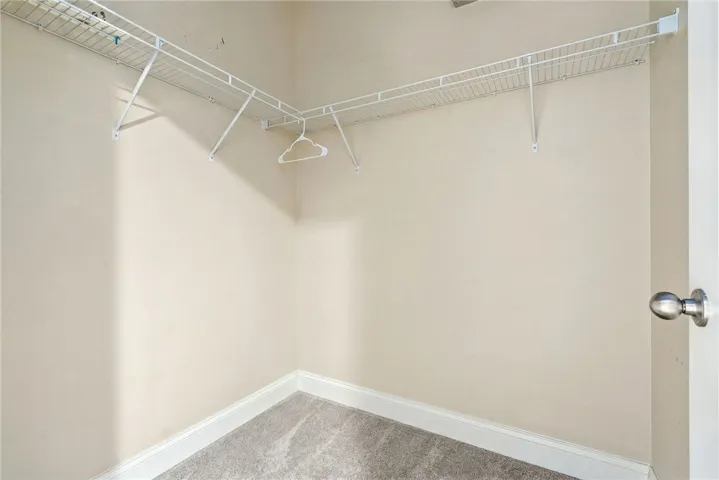 Organized living with convenient wire shelving provides ample storage in this well-kept closet.
