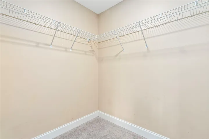 Functional wire shelving provides practical storage solutions for any wardrobe.
