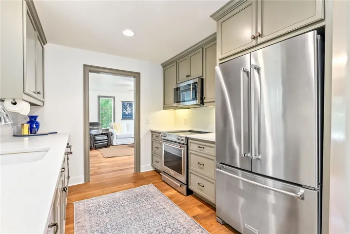 This modern kitchen features warm wood floors and sleek appliances, perfect for everyday living.