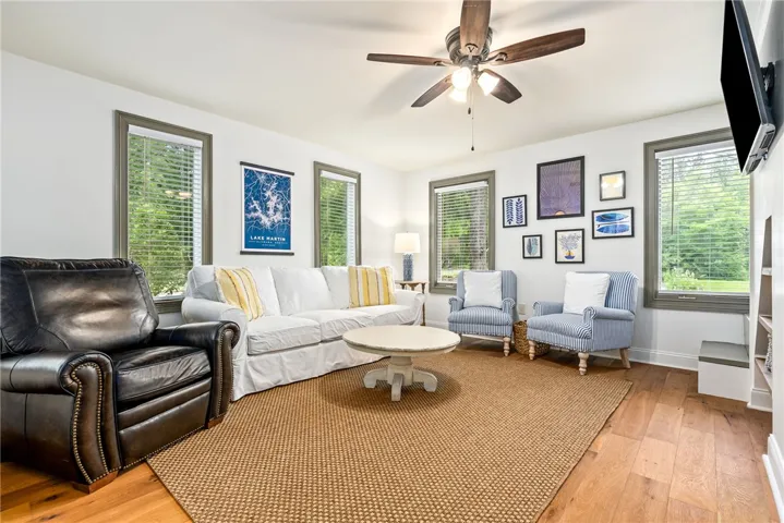 This bright living area features abundant natural light and rich wood flooring.