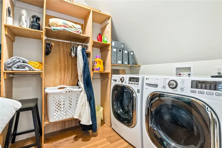 This organized laundry area features convenient shelving and modern appliances for efficient home management.