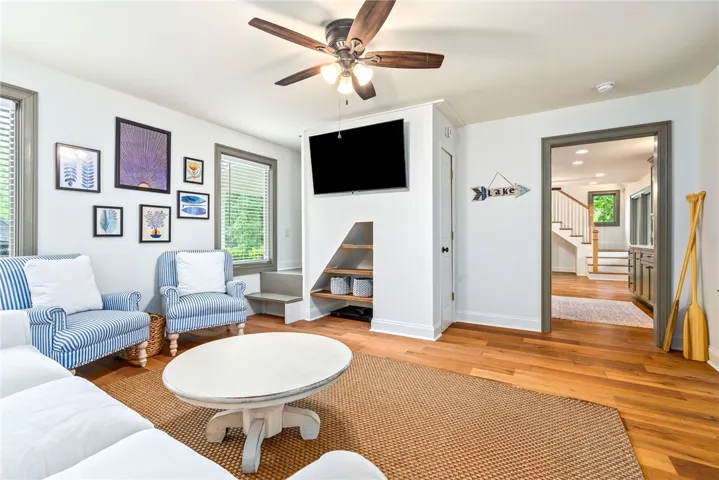 This living area offers a welcoming atmosphere with hardwood floors and ample natural light.