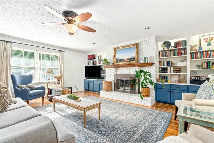 Huge inviting family room with a gas fireplace and built in bookcases.