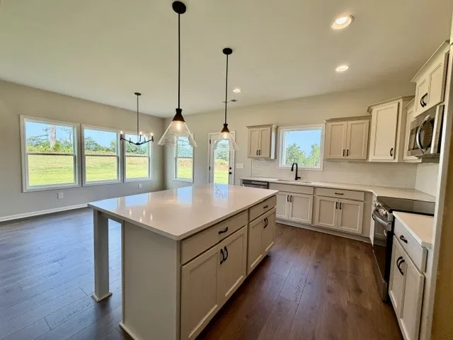 A spacious, open-concept kitchen features a large island, perfect for culinary endeavors and casual dining.