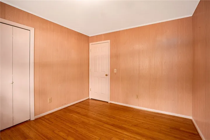 A versatile room with durable wood flooring awaits your personal touch.