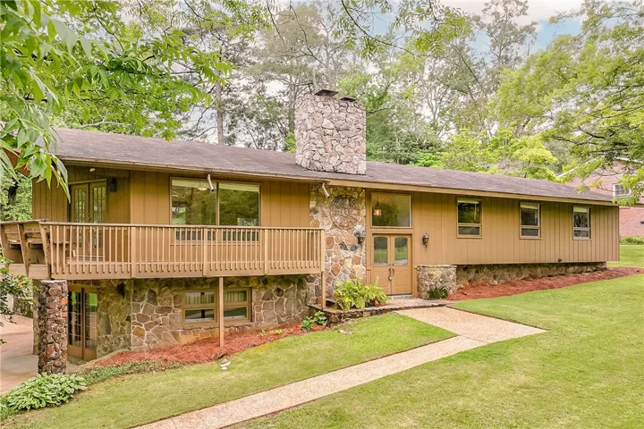 A stone-clad facade with a charming front path creates inviting curb appeal for this distinctive residence.