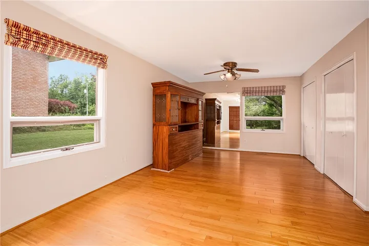 Natural light illuminates polished hardwood floors in this welcoming interior space.