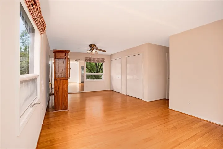 Hardwood flooring extends through this airy living space with ample natural illumination.