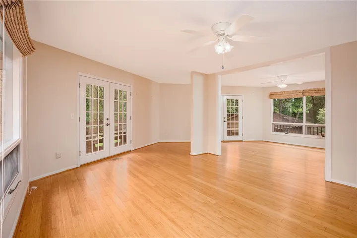 Hardwood floors and generous windows create a light-filled living space with outdoor access.