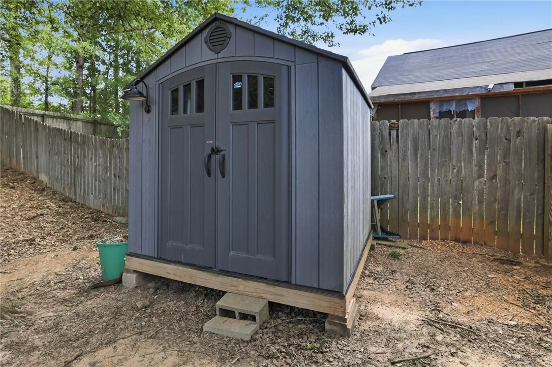 This outdoor shed provides ample storage, enhancing property functionality.