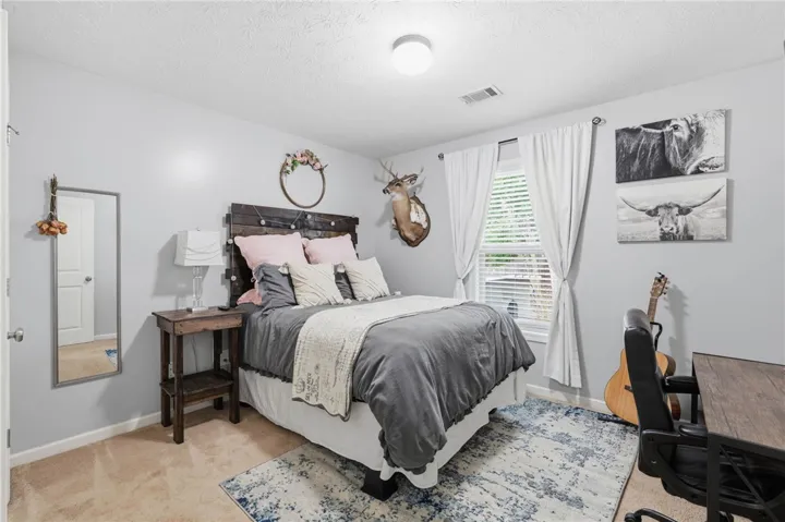 This cozy bedroom offers a large window admitting ample natural light.
