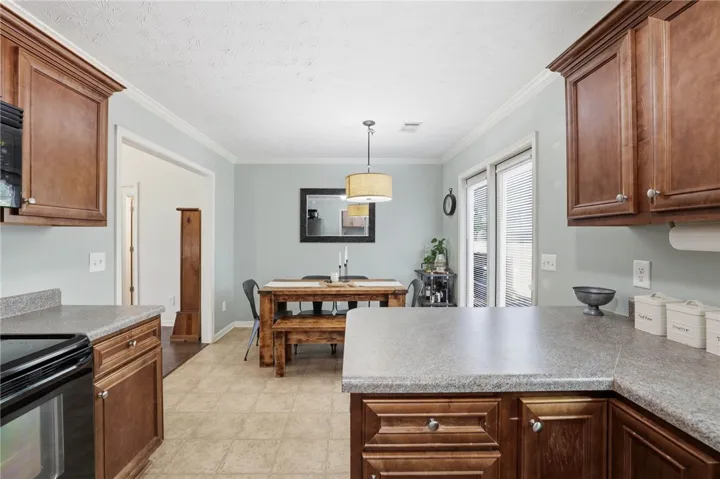 This inviting kitchen and dining area offers ample space and tasteful cabinetry for everyday living.
