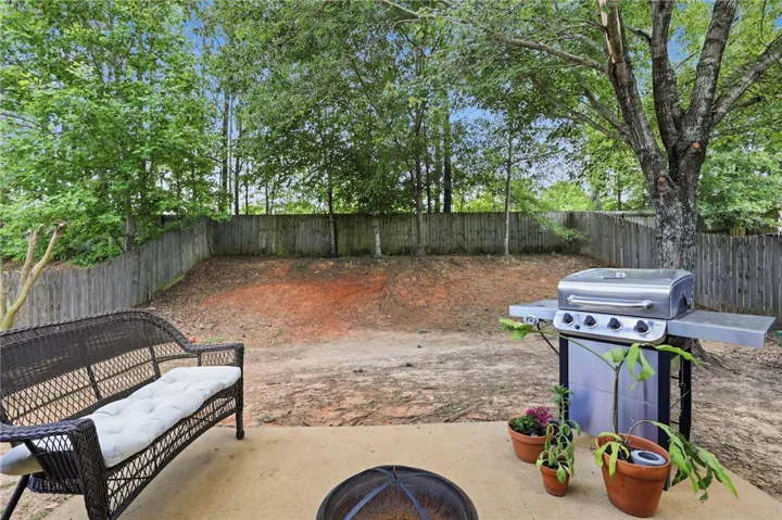 Enjoy outdoor living in this private yard with a paved patio, perfect for grilling and relaxation.