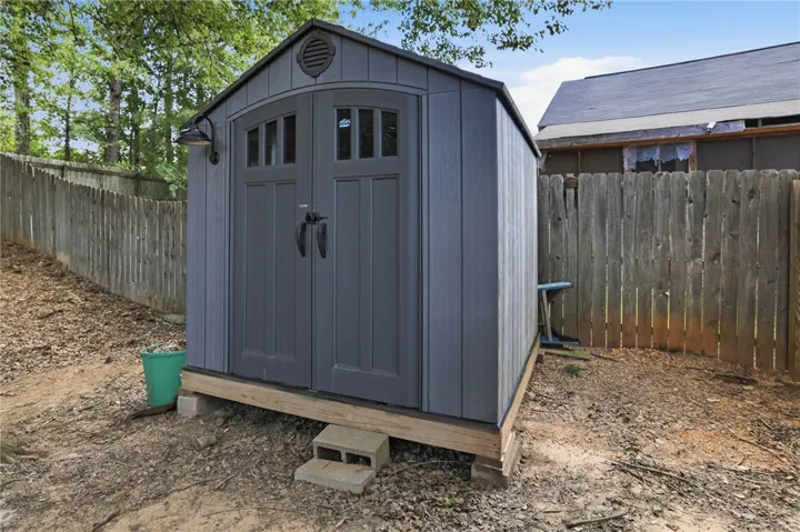 This outdoor shed provides ample storage, enhancing property functionality.