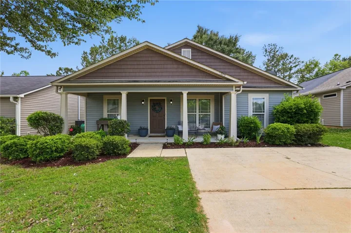 Charming bungalow offers inviting curb appeal and a well-maintained front yard with mature landscaping.