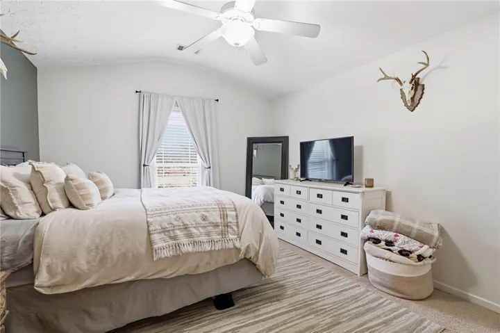 This tranquil primary bedroom offers comfort and a relaxed atmosphere.