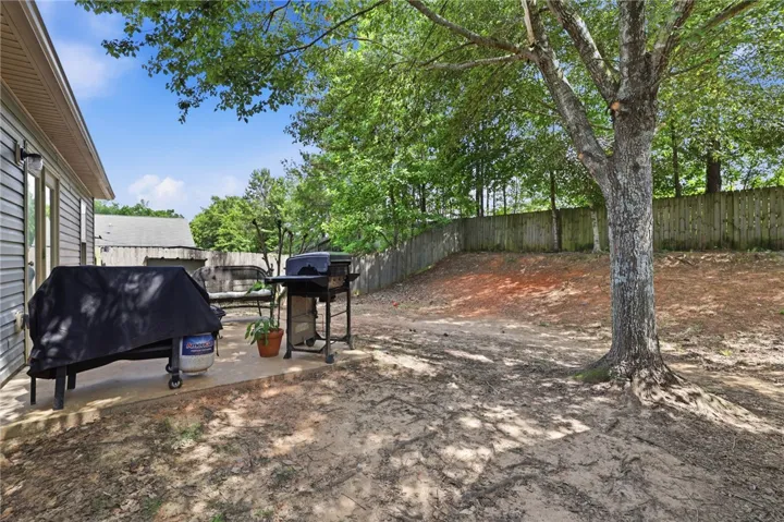A spacious backyard with a patio, providing ample outdoor entertaining and relaxation space.