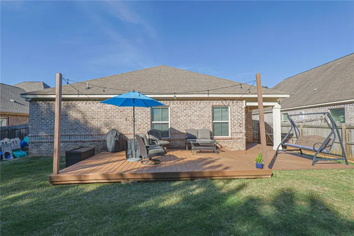 This inviting backyard deck offers an ideal space for outdoor enjoyment and relaxation.