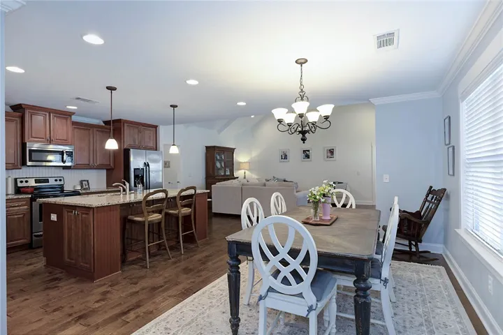 This inviting space combines a functional kitchen with a cozy dining area and comfortable living room.