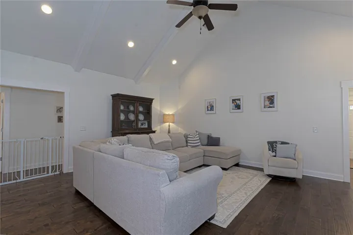 This living room features high vaulted ceilings and rich hardwood flooring.