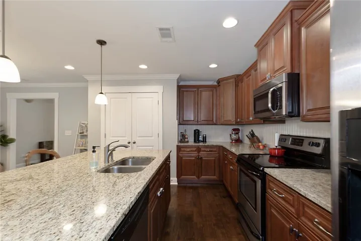 This functional kitchen provides a generous island and ample cabinetry for culinary pursuits.