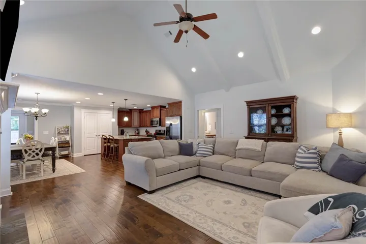 This spacious open-concept living area features vaulted ceilings and rich hardwood floors.